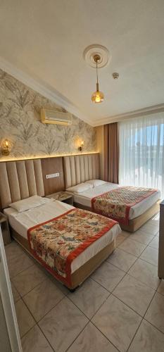 a hotel room with two beds in a room at Gazipasa Star Otel in Side