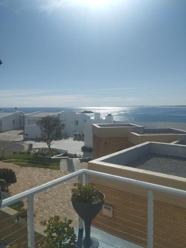 a balcony of a building with a view of the ocean at Sea Echo in Yzerfontein