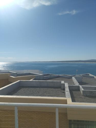 a view of a building with the ocean in the background at Sea Echo in Yzerfontein