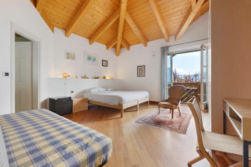 a bedroom with a bed and a desk and a chair at Bnb Casa Fiore in Madice