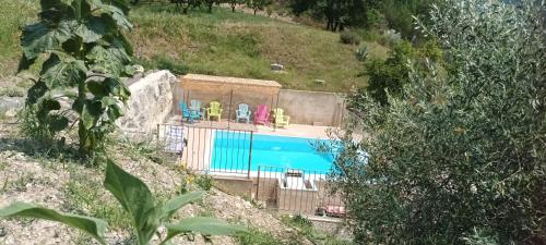 a swimming pool with chairs on top of it at La glycine in Sahune