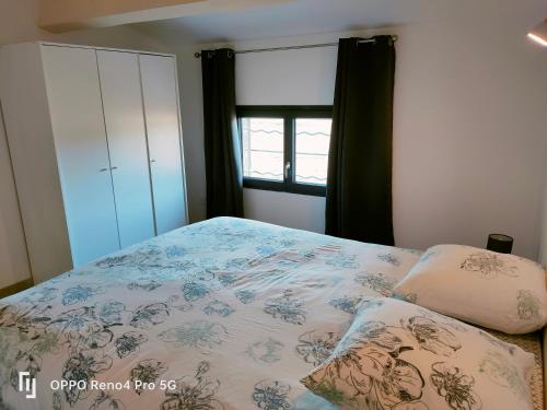 a bedroom with a bed and a window at Domaines des confines in Monteux