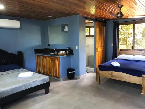 a bedroom with two beds and a bathroom with a sink at Club Fred in Punta Mala