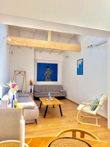 a living room with a couch and a table at Si apartments Free Parking in Sofia