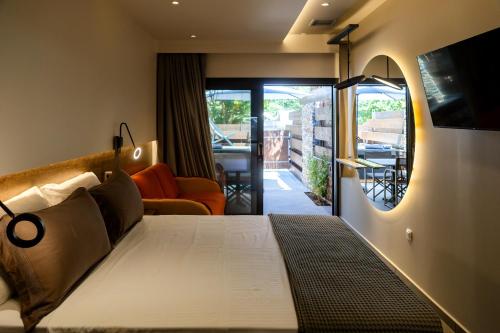 a hotel room with a bed and a balcony at Sylvia Camping & Luxury Suites in Litochoro