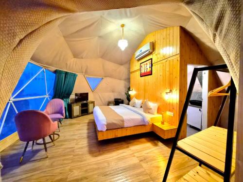 a bedroom in a tent with a bed and a chair at Glamp by Edge Resort Premium Luxury Domes with Mountain Views in Mussoorie