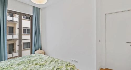 a bedroom with a bed and a window at Royal Hamilius Luxury 1 bed in Luxembourg