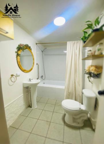 a bathroom with a toilet and a sink and a tub at Taltal - Casa Nordic in Taltal
