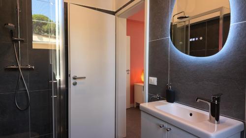 a bathroom with a sink and a mirror at Villa Mario in Senigallia