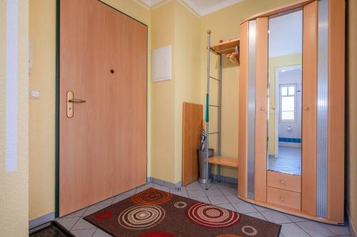 a bathroom with a shower and a door with a rug at Ferienwohnung Koralle in Koserow