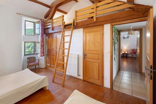 a room with a bunk bed and a ladder at Chambres Et Table D'hôtes De Vernet in Saint-Germain-de-Calberte