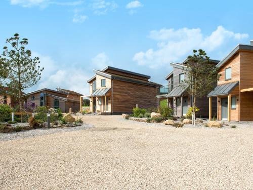 a row of houses on a gravel driveway at Una Argentum 60 in Carbis Bay
