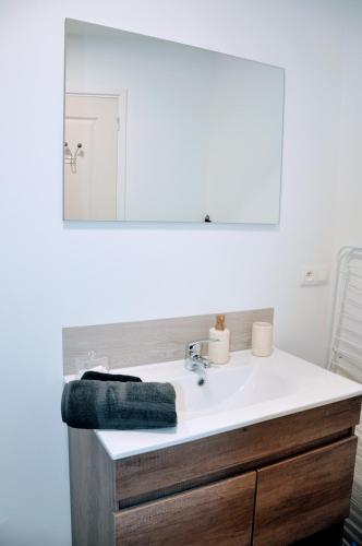 a bathroom with a white sink and a mirror at Dormir près de Brioude - studio 'esprit vacances' in Fontannes