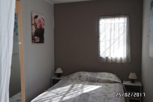 a bedroom with a bed and a window at Mas Grimaud - Gîte- Studio et chambres d'hôtes familiales in Eygalières