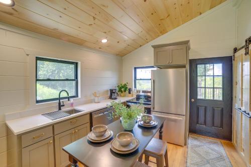 a kitchen with a table and a refrigerator at Off-Grid & Solar-Powered! Mtn-View Omaha Cabin in Omaha