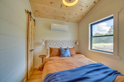 a bed in a small room with a window at Off-Grid & Solar-Powered! Mtn-View Omaha Cabin in Omaha
