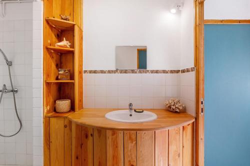 a bathroom with a sink and a mirror at Studio La Chambrette in Blieux