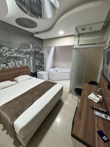 a bedroom with a bed and a tv and a table at Add Hotéis Center Norte in São Paulo