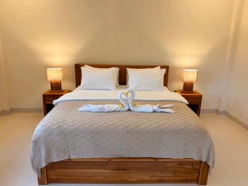 a bedroom with a bed with swans on it at Kayana Amed in Amed