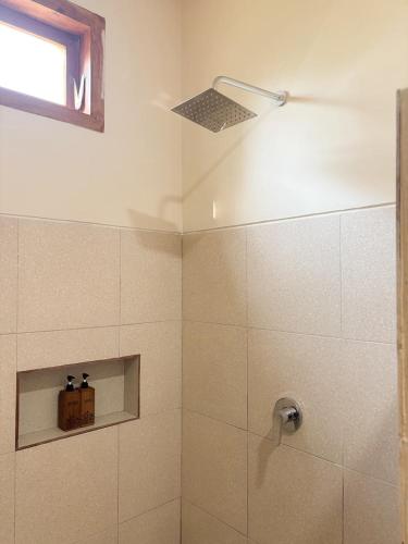 a bathroom with a shower with a shower head at Kayana Amed in Amed