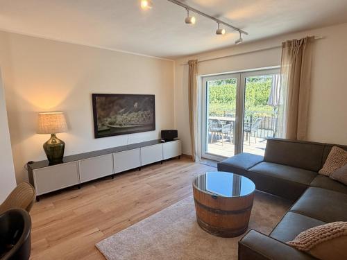 a living room with a couch and a table at Gimmeldinger Haus in Neustadt an der Weinstraße