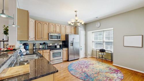 a kitchen with a sink and a refrigerator at Rehoboth Crossing --- 19913 Ames Drive #106 in Rehoboth Beach