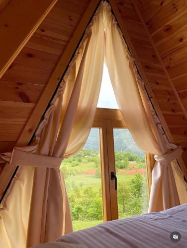 a bedroom with a bed and a window at Vista Verde in Žabljak