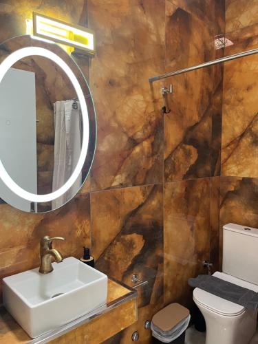 a bathroom with a sink and a mirror at Rafael & Sofia Luxury Suites in Ammoudia