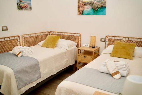 two beds sitting next to each other in a room at Villa RiRò Bari in Bari