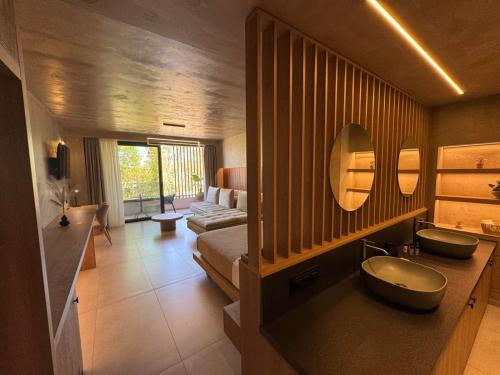 a bathroom with two sinks and a mirror at Elegance Suites in Pyrgos