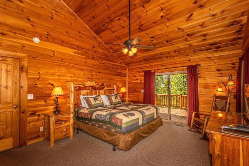 a bedroom with a bed in a log cabin at Shooting Star Ridge in Whittier