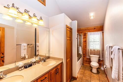 a bathroom with a sink and a toilet and a mirror at Shooting Star Ridge in Whittier