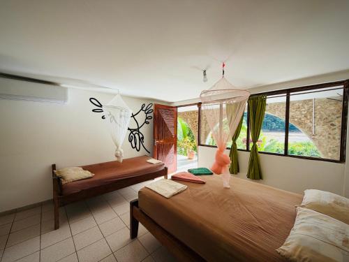 a bedroom with two beds and a window at Lobo Hostel Rurrenabaque in Rurrenabaque