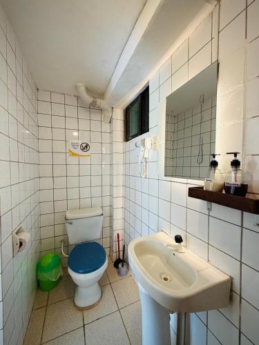 a bathroom with a toilet and a sink at Lobo Hostel Rurrenabaque in Rurrenabaque