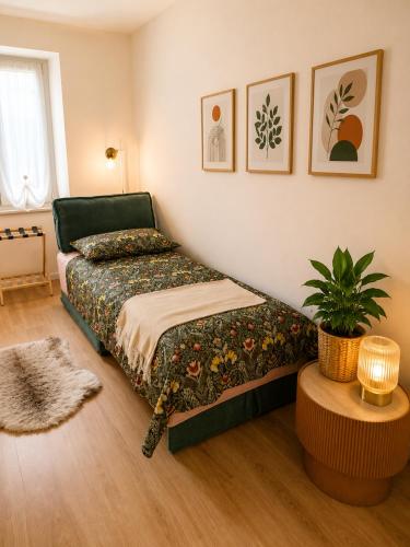 a bedroom with a bed and a potted plant at Casa Giulio Collio Suite in Cormòns