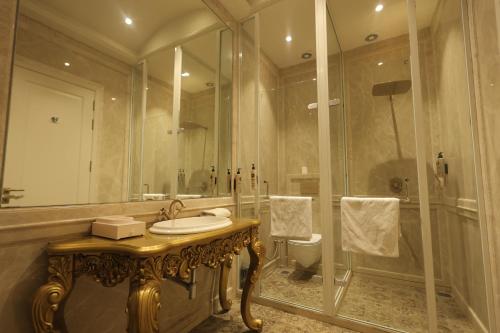 a bathroom with a sink and a shower at Rajwada Hotel and Resort in Bareilly