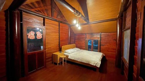 a bedroom with a bed and a table in it at Ako BM homestay in Buon Ma Thuot