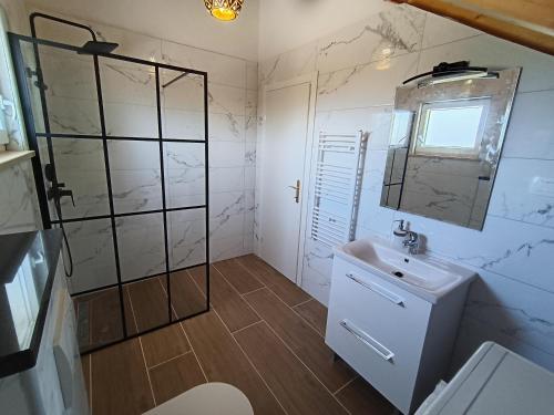 a bathroom with a sink and a shower at Vila Nikola in Pučišća