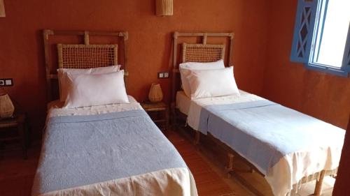 a room with two beds in a room at Riad chrifa in Tangier