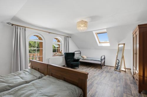 a bedroom with a bed and a chair at Vila v Lahošti in Teplice