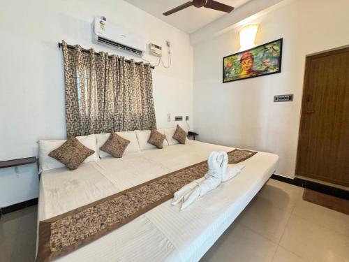 a large white couch in a room with a window at La Paradise Residency - TIE in Pondicherry