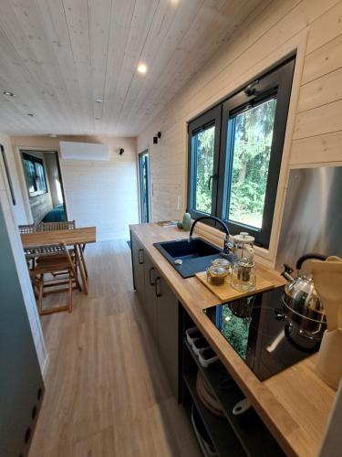 eine Küche in einem Minihaus mit Spüle in der Unterkunft Tiny House in Weismes