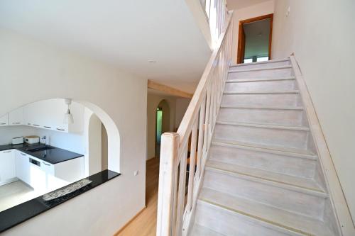a staircase leading up to the kitchen in a house at FLH - Casa Cascada in Fîntînele