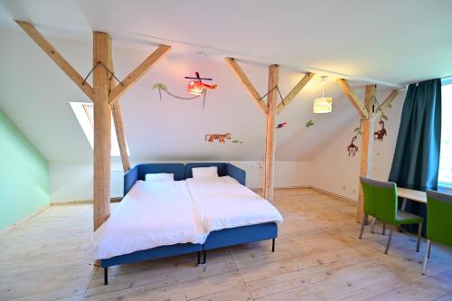 a bedroom with a bed and a table and chairs at FLH - Casa Cascada in Fîntînele