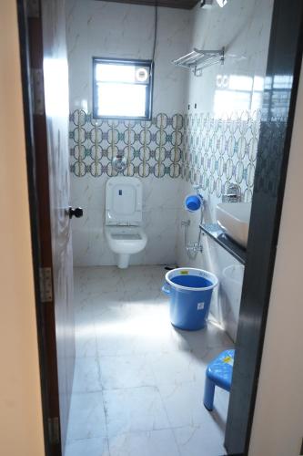 a bathroom with a toilet and a sink at Shri Prasad Executive in Pandharpur