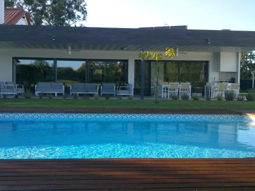 a large swimming pool in front of a house at Monte Girassol - The Lisbon Country House! in Quinta das Faias