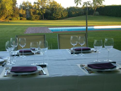 a table with wine glasses and napkins on it at Monte Girassol - The Lisbon Country House! in Quinta das Faias
