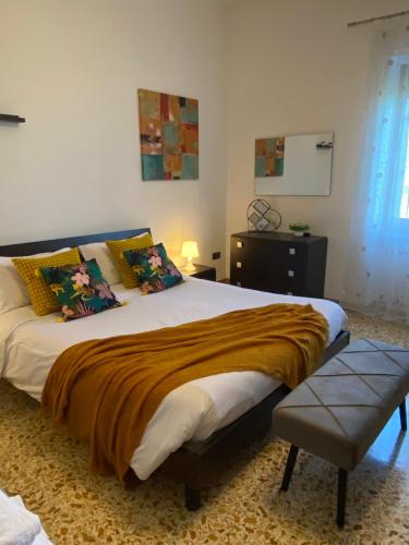 a bedroom with a large bed with a brown blanket at Sotto la Torre - dimora elegante con vista sulla valle in Caiazzo