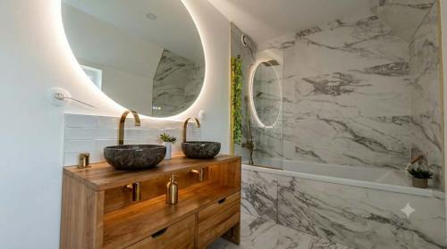 a bathroom with two vessel sinks and a tub at Le Bosquet-Villa Prestige, Parking privé, Jardin, Wifi in Lys-lès-Lannoy