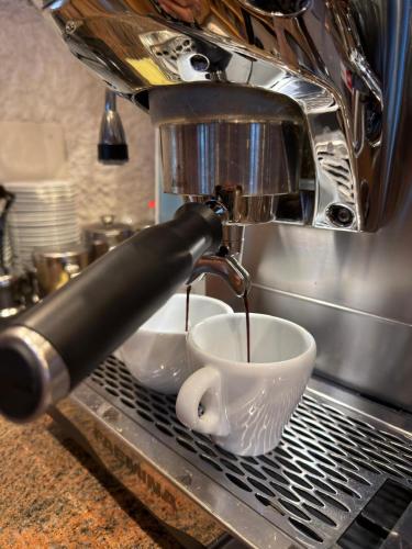 a coffee maker is making a cup of coffee at Mazot Zermatt in Zermatt